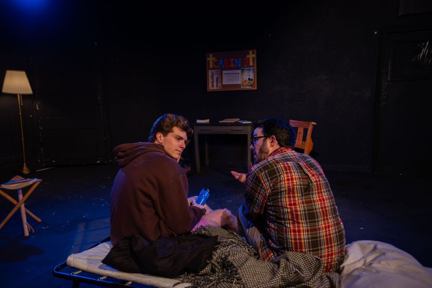 On the left in a dark hoodie Josh (Luke Stiles) deep in conversation with on the right in a check shirt Paul (Diego Zozaya).